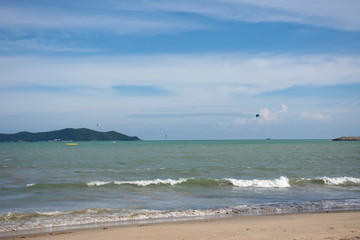 Fototapeta na wymiar Thai athletes and foreigner people practicing sports and playing kiteboarding or sea kite in the ocean in Rayong, Thailand