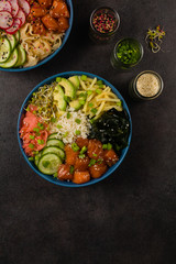 Hawaiian salmon poke bowl with seaweed, avocado, sesame seeds.