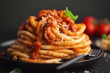 Tasty pasta bolognese with cheese and basil