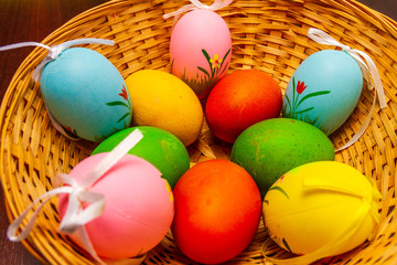 Colorful easter eggs in a basket isolated 