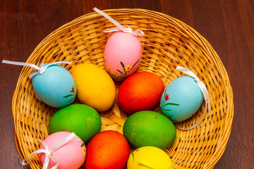 Colorful easter eggs in a basket isolated 