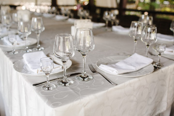 Fototapeta premium Crystal dishes on a restaurant table, open background.
