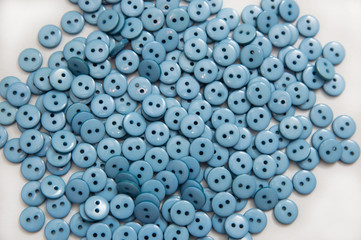 plastic plastic buttons pellets scattered on a white background