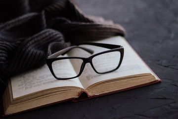 Glasses on the pages of an open book.