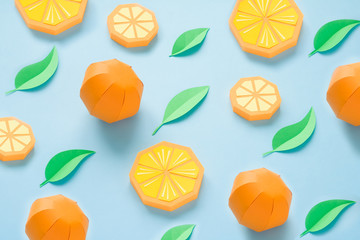 Fruit made of paper. Blue background. There's room for writing. Tropics. Flat lay. Orange, lemon.