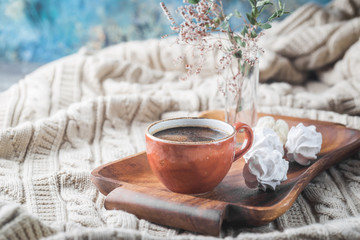 Obraz na płótnie Canvas Hot Coffee cup on tray over background of the plaid