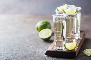Mexican Gold Tequila with lime and salt on black background with copyspace.
