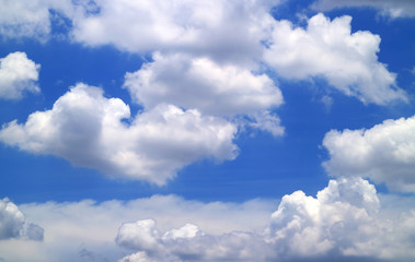 White clouds on vivid blue sky on sunny day for background and banner