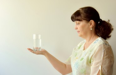 woman holding a glass of water