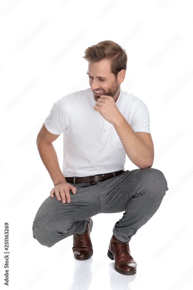 Sticker lughing crouched smart casual man thinks and looks to side