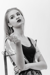 Fashionable black and white shot of a model dressed in black swimming suit and transparent rain...