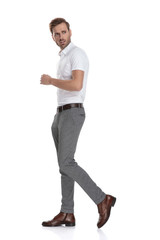 Fototapeta premium serious or worried young casual man walks and looks back