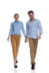 Fototapeta premium young happy casual couple walking and holding hands