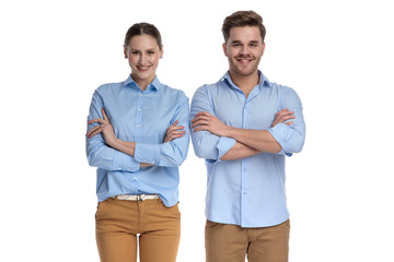 casual couple standing together with hands crossed