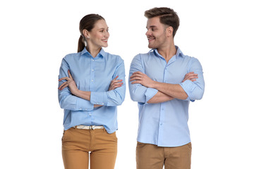 couple standing with hands crossed looking at each other