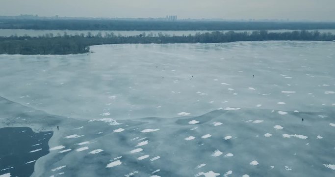 Aerial drone footage of frozen river in winter day.Flying quadro copter camera shoot video of ice on sea water surface in cold season.Beautiful landscape from above.Travel destination for tourism