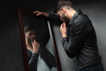 narcissist sexy young man admiring himself in the mirror