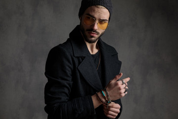 Interesting man arranging his bracelets