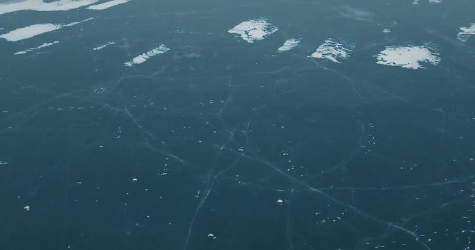 Aerial drone footage of frozen river in winter day.Flying quadro copter camera shoot video of ice on sea water surface in cold season.Beautiful landscape from above.Travel destination for tourism