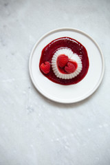 Vegan coconut Raspberry panna cotta decorated with ripe berry