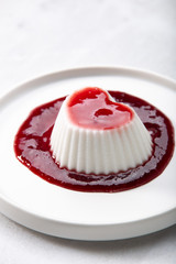 Vegan coconut Raspberry panna cotta decorated with ripe berry
