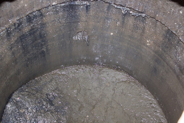 open sewage septic tank,a toilet is filled in a sewage pit, a sewage pit is open
