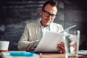 Lawyer reviewing contract in his office