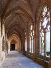 Fototapeta na wymiar Vaulted arcade in cloister of Monastery of Santa Maria de Santes Creus