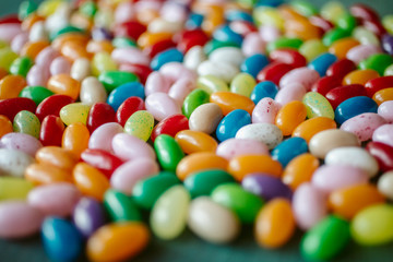 Colorful candy beans as texture and background. Close up view of jelly beans with selective focus. 