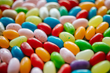 Fototapeta na wymiar Colorful candy beans as texture and background. Close up view of jelly beans with selective focus. 