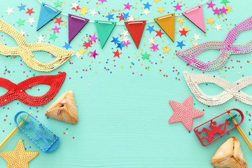 Purim celebration concept (jewish carnival holiday) over wooden blue background