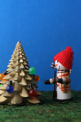 Snowman decorating christmas tree