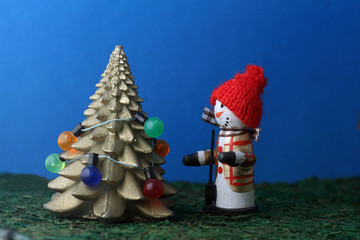 snowman decorating christmas tree