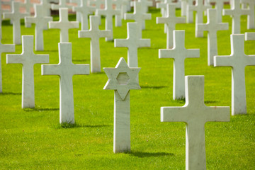 Rows of cross and Jewish tombstones on cemetery