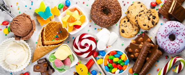 Fototapeten Selection of colorful sweets - chocolate, donuts, cookies, lollipops, ice cream top view © anaumenko