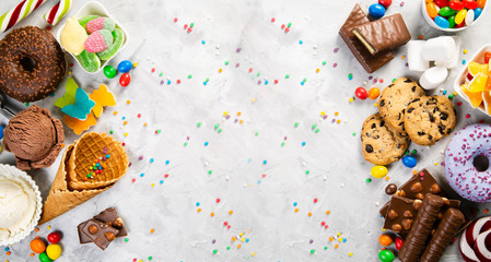 Selection of colorful sweets - chocolate, donuts, cookies, lollipops, ice cream top view - Powered by Adobe