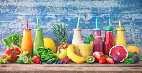 Colorful freshly squeezed fruits and vegetables smoothies with ingredients for healthy eating