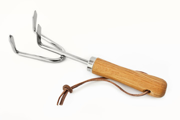 Gardening hand tools rake against wihite background