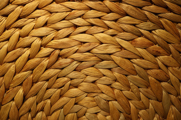 Beautiful pattern of golden brown color woven water hyacinth place mat for background or banner