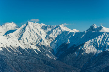 Obraz premium Beautiful landscape view of mountains covered on snow with dark and brown hills in the foreground