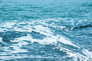 Abstract blue sea water with white foam for background, nature background concept