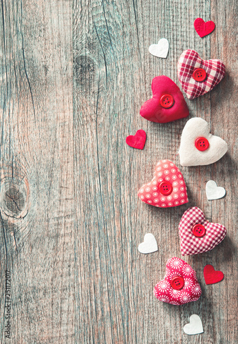 Handmade  textile hearts over wooden table
