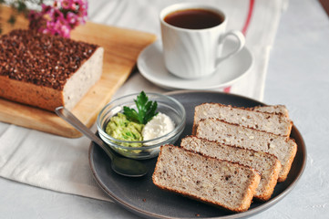 Fototapeta na wymiar Healthy and proper Breakfast. Sandwich with avocado and homemade bread on sourdough of green buckwheat with flax seeds, sunflower. Raw and vegan food.