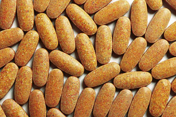 Closeup natural vitamin supplements on the white background. Top view. Flat lay