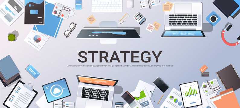 business strategy marketing plan concept top angle view desktop laptop smartphone tablet screen paper documents financial analysis report office stuff horizontal
