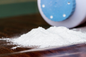 Baby talcum powder container on wooden background