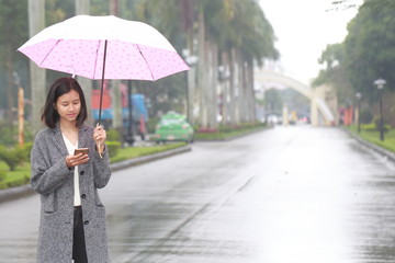 woman walking with an umbrella in the rain