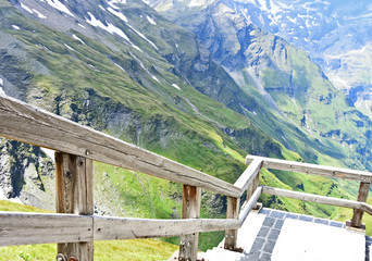 Fototapeta premium The Grossglockner (German name is Großglockner) in summer with mountain view and wooden Railing