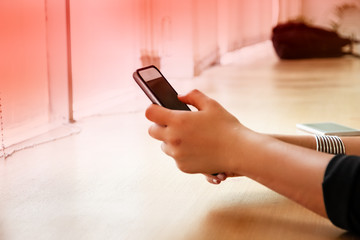 The abstract art design background of humand hand using mouile phone,touching on screen ,hipster hands texting mobile phone,graduated user defined effect,blurry light around