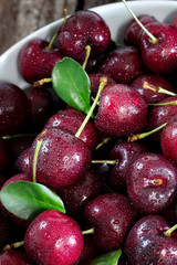 Bowl of fresh red cherries on wooden background, close up - Image